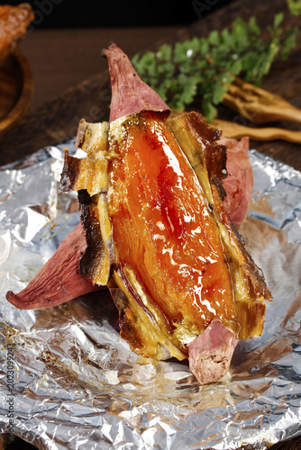 Delicious Roasted Sweet Potato with Caramelized Skin on Aluminum Foil - Healthy Comfort Food Still Life Photography