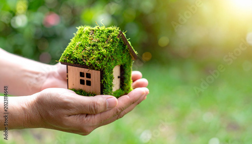 Eco Friendly Green House in Human Hands Sustainability and Environmental Concept