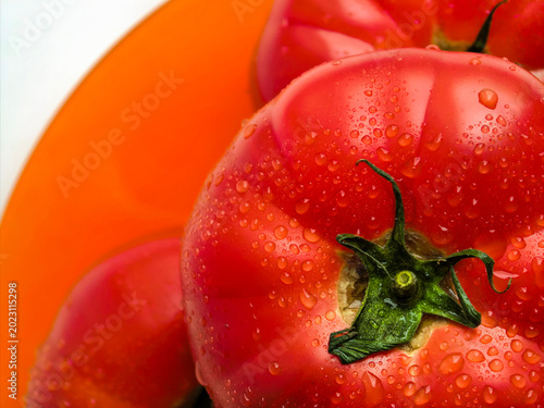 Macro Fresh Tomato On Orange Plate Close Up