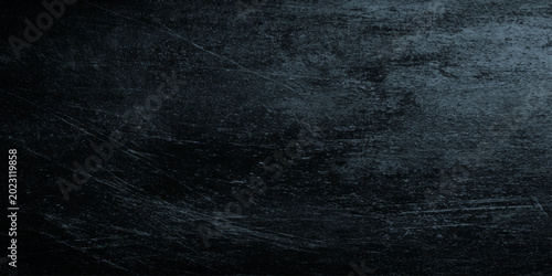 Fotografie Dark grungy black background with scratched texture and vintage aesthetic for cr