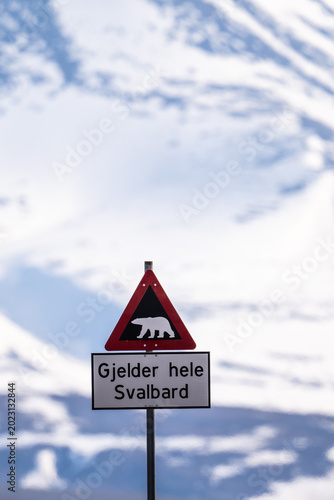 A polar bear warning sign is posted in Svalbard, Norway, indicating the presence of polar bears in the area.