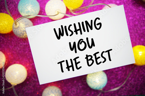 Wishing You The Best text written on paper card with LED cotton balls decoration