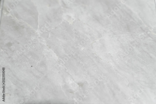 A collection of natural material samples is displayed in an organized composition featuring sintered stone, granite, and transparent glass textures. Each surface reveals unique veins, grains, reflecti