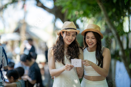 Young asian women friends sharing travel memories