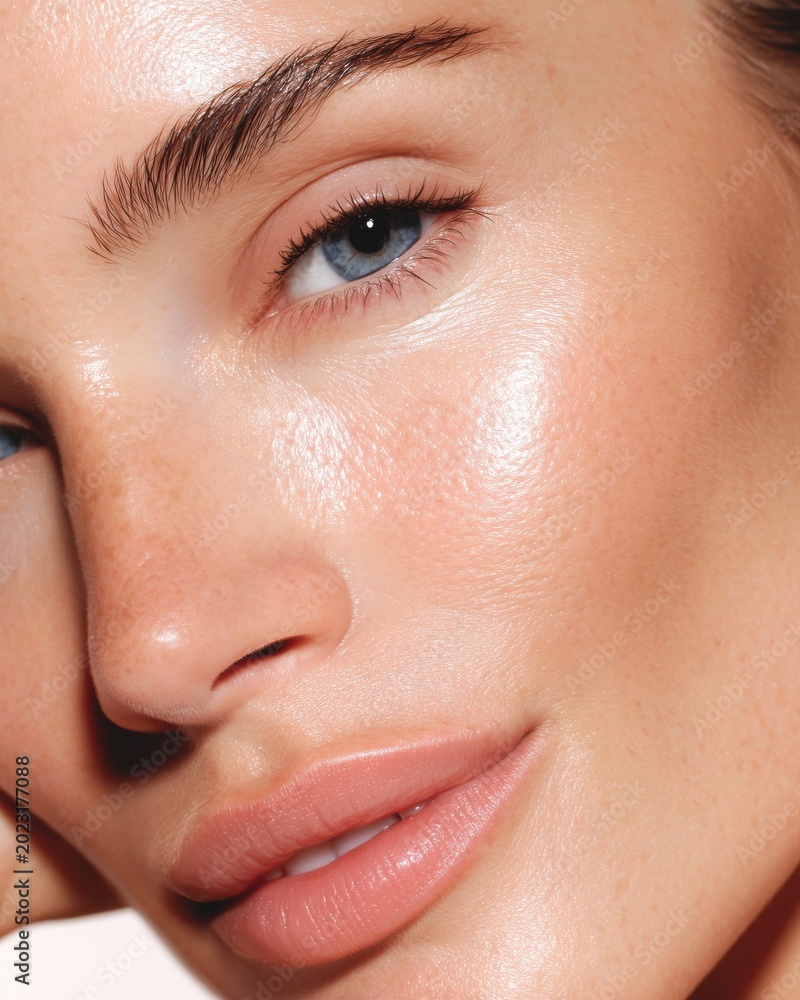 Fototapeta premium Woman glowing skin closeup nude lips blue eyes beauty portrait