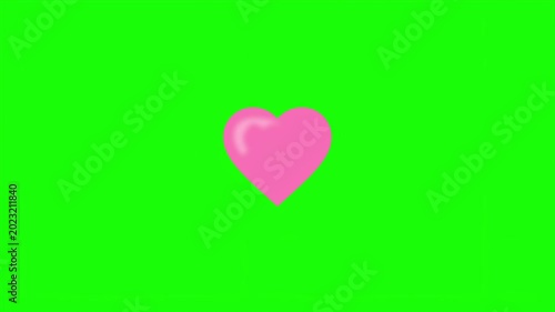 A pink heart appears on a green chroma key background