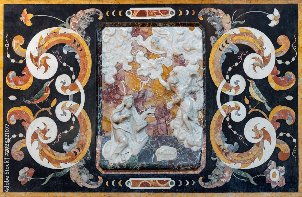 Fototapeta premium CREMA, ITALY - MARCH 20, 2026: The stone baroque relief of Annunciation in the church Chiesa della Santissima Trinita by unknown artist of 18. cent. 