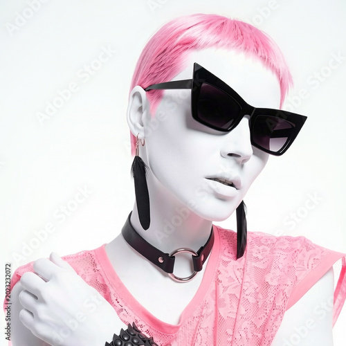 Close up portrait of futuristic mannequin with white skin and pink hair wearing cat eye sunglasses, gothic choker with metal ring and pink lace top, cyber fashion concept