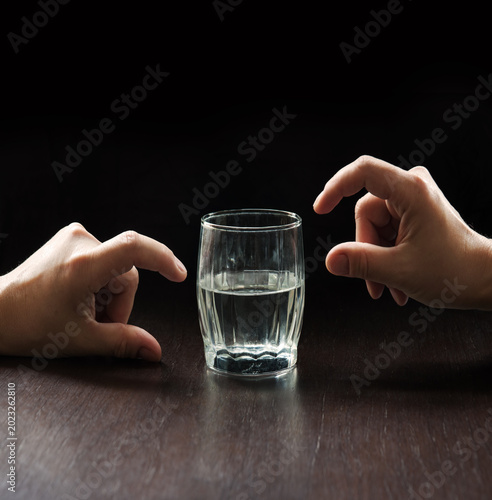 Fényképezés An optimist and a pessimist's opinion about a glass of water