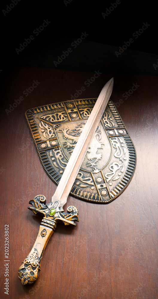 Fototapeta premium Iron shield and sword on the table