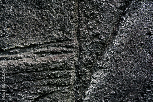 Φωτογραφία close up of a dark grey rough concrete wall texture with organic grainy patterns