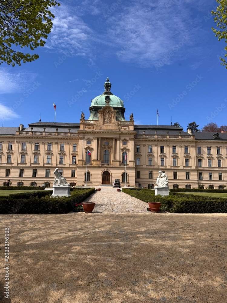 Fototapeta premium Straka Academy in Prague is a striking neo-baroque government building on the Vltava River in Malá Strana, serving as the Czech government seat since 1993 with gardens open seasonally visitors