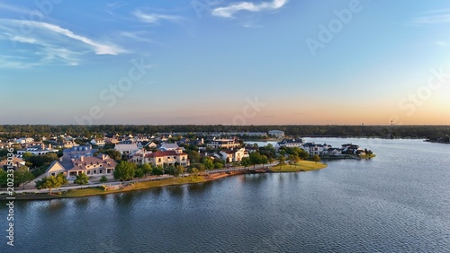 Aerial view of luxury houses in Houston, Woodlands by the lake with dramatic cloudy sky in Texas, United States