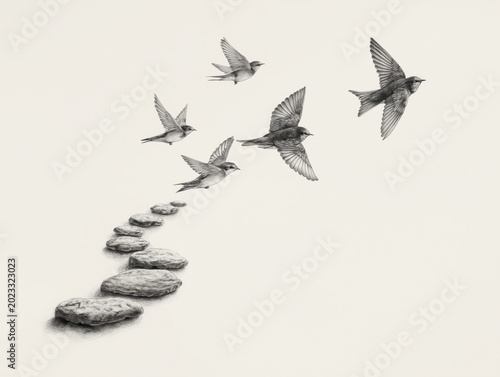Several small swallow birds flying away from a curved line of gray stones on white background