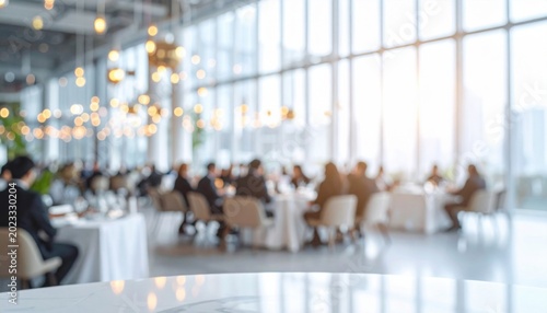 Blurred corporate executives dining at a formal business gala banquet inside a spacious luxury restaurant venue with bright window lighting