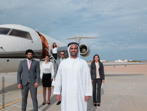 Photography Middle Eastern business team disembarking private jet showing corporate leadersh