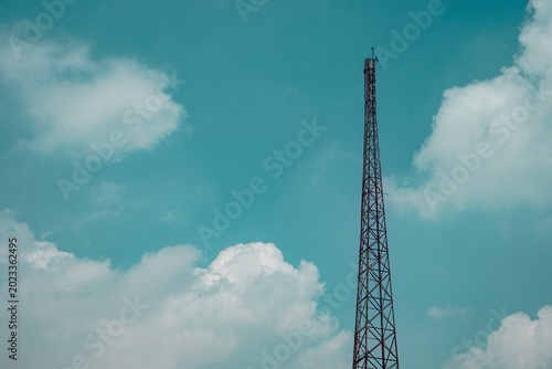 Minimalist view of a steel lattice communication tower against sky