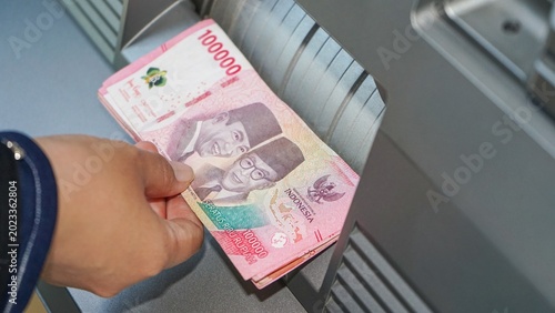 Indonesian rupiah banknotes counted through modern cash machine