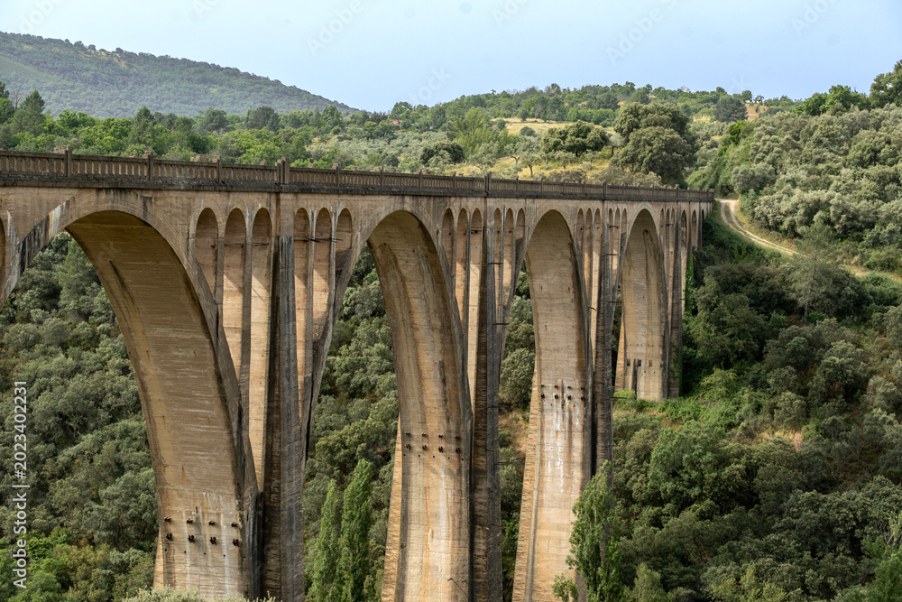 Fototapeta premium The grandiose viaduct on the doorstep of Guadalupe , Spain crossing the rugged valley of the Guadalupejo. At 274 metres long and 58 metres high it was one of the largest bridges in Spain.