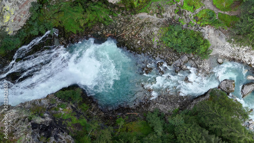 Majestic river flows through lush greenery, showcasing nature's vibrant beauty in a serene landscape