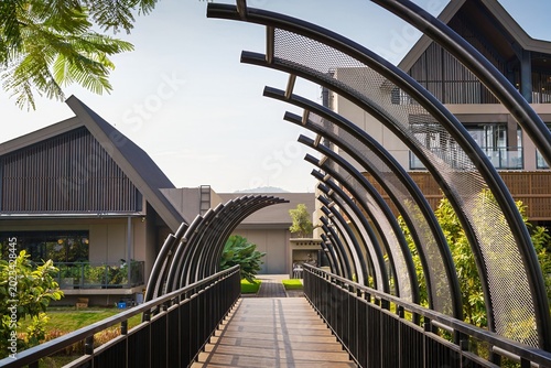 Modern pedestrian bridge with curved steel arches and geometric perspective