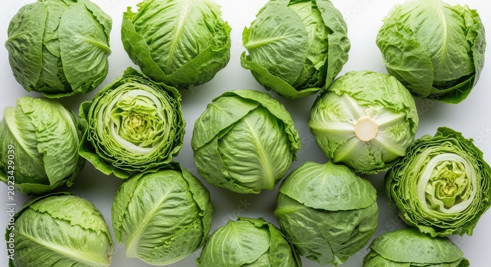 Fototapeta premium Overhead shot of fresh iceberg lettuces arranged closely on a white surface, showcasing the vibrant green color and crisp leafy texture, crisp, ingredients, pile