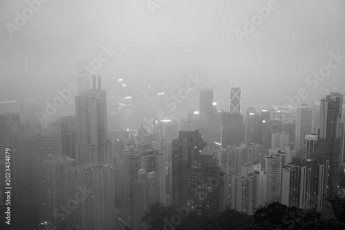 Hong Kong skyline shrouded in mist, showcasing dense urban landscape and skyscrapers