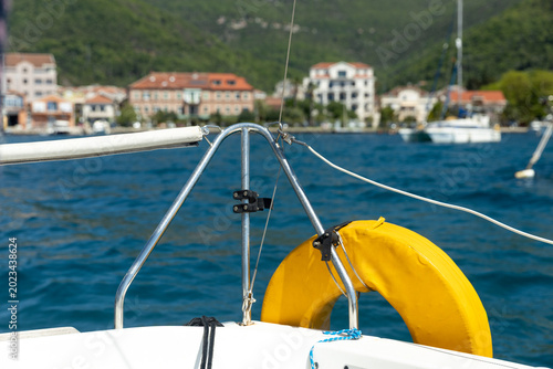 A view of the city, on the seashore, from the bow of a small yacht