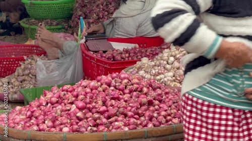 Close-up view of fresh shallots and garlic sold at traditional market in Vietnam Authentic local street market scene showcasing colorful vegetables, daily life and Asian food culture in Southeast Asia