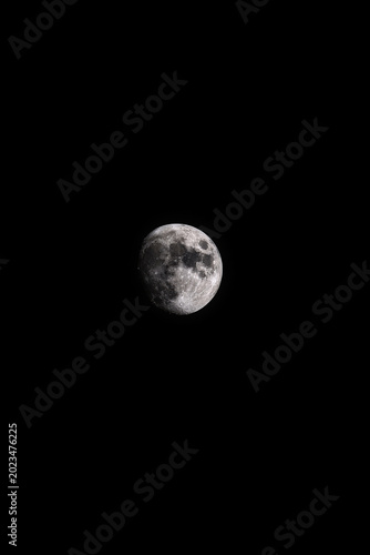 Fotografija Detailed view of the moon in a vast, dark expanse of space.