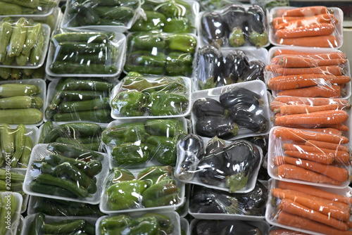 Fresh vegetables wrapped in plastic at market