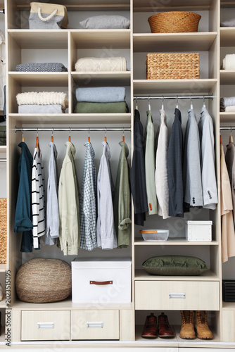 Fotografía Wardrobe with different stylish clothes, accessories, shoes and home stuff indoo