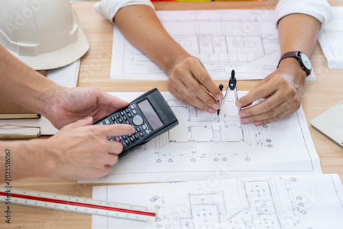 Bild auf Leinwand Calculating project costs construction planning office setting work documentatio