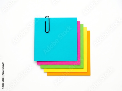 Colorful sticky notes with paperclip on white background for office supplies