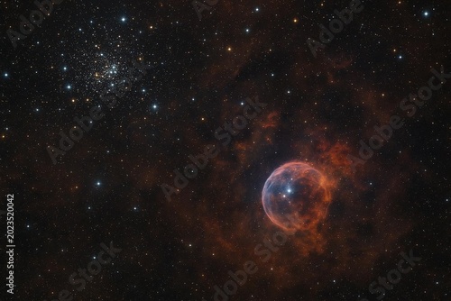 Stars and clouds in space highlight a nebula and globular cluster at night in a clear view of the universe from Earth