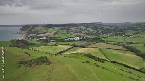 Aerial Drone View of Patchwork Green Fields and Distant Coastline in Dorset Countryside England