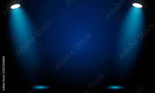 Spotlights shining down on a dark blue background with beams of light