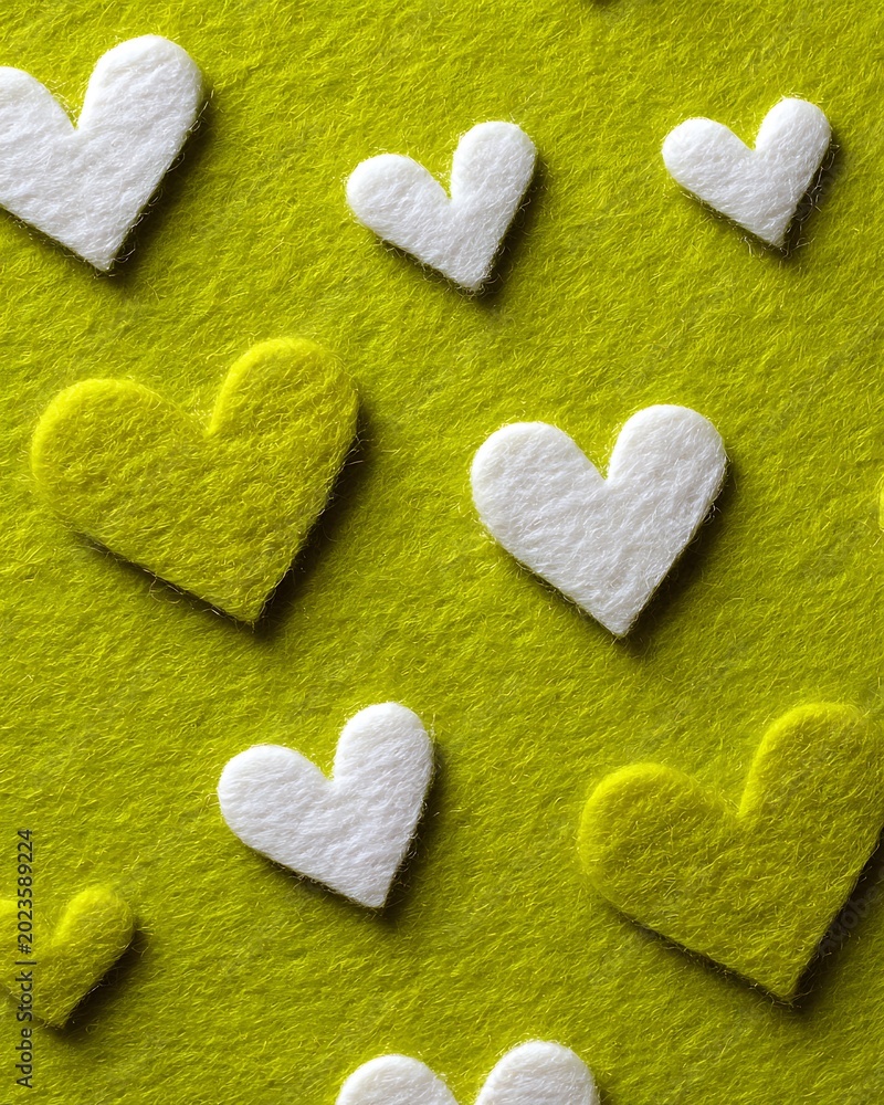 Obraz premium Green matcha powder covers white surface with heart-shaped cutouts, creating playful and romantic layout for product or branding design