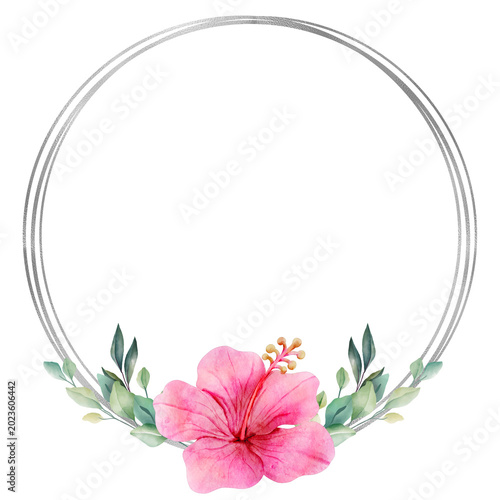 Beautiful pink hibiscus flower with green leaves arranged in a silver round frame for decoration