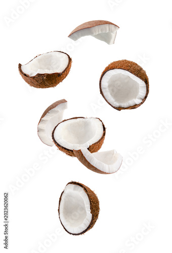 Perfectly retouched coconut halves and slices fall into space.