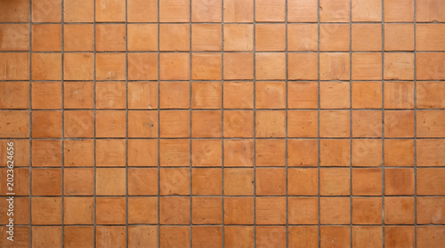 Фотография Terracotta square ceramic tiles wall texture background