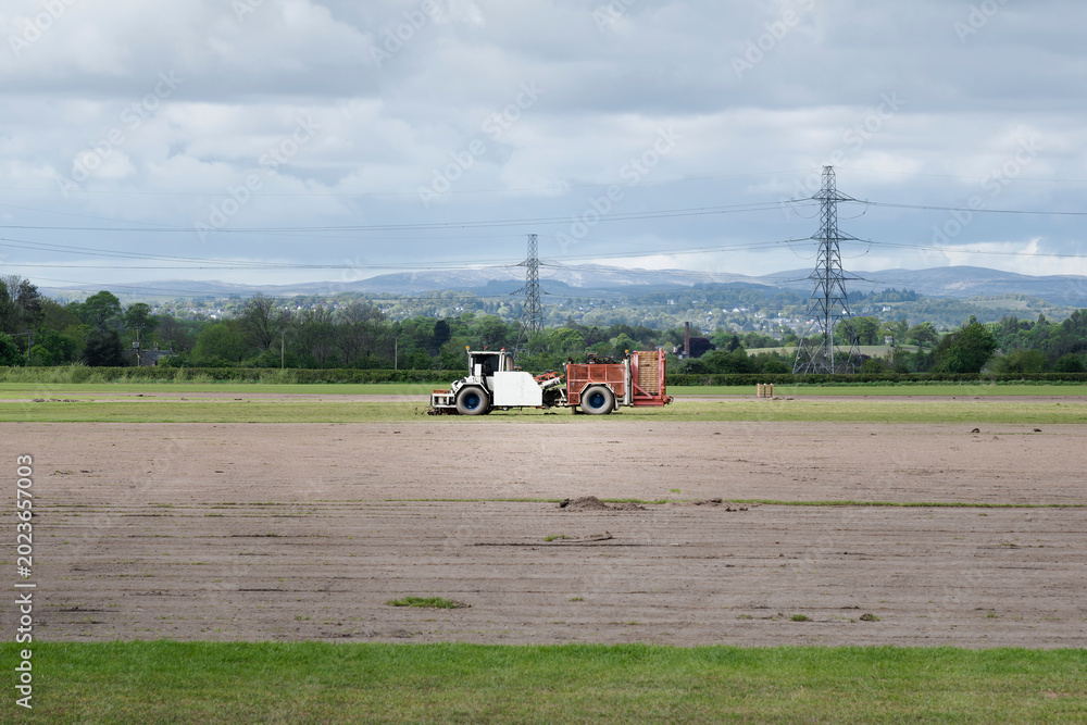 Fototapeta premium Combine harvester harvesting crops in Scotland