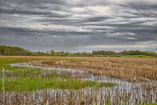 Dark clouds cover the flooded landscape on a day in early May at the Horicon Marsh Wildlife Refuge, near Horicon, Wisconsin.