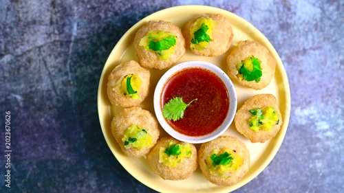 Close up of Indian street food fuchka on a plate glass with sour spicy water. Dahi Pani puri a chat item in India. 4K indian street food snacks.