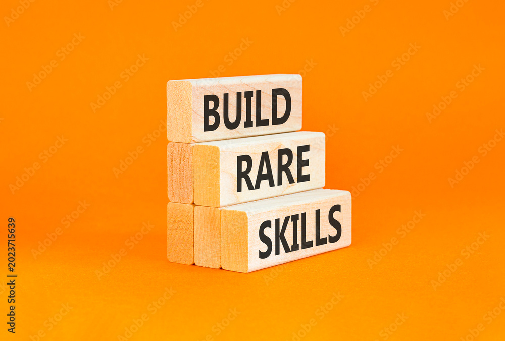 Naklejka premium Build rare skills words symbol. Concept words Build rare skills on beautiful wooden blocks. Beautiful orange background. Business and build rare skills concept. Copy space.