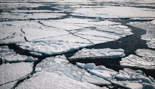 Foto Aerial fly over view of cracked ice floes floating in the sea