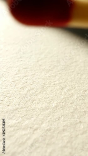 Close up of match head and flame ready on textured surface