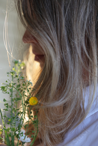 Woman holding Flowers close up. Seasonal Allergy and Spring Bloom Concept