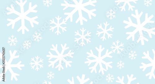 Simple winter themed seamless pattern with various sizes of white snowflakes scattered across a soothing light blue background for holiday decor.