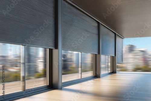 Electric roller shutters on a modern building facade. Home security and window protection system. Contemporary architecture with automated blinds
